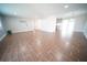 Open-concept living room featuring wood floors, recessed lights, neutral walls and large windows at 105 E North Branch Rd, Ruskin, FL 33570
