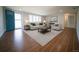 Staged living room with wood-look tile, neutral furniture, and bright natural light at 105 E North Branch Rd, Ruskin, FL 33570