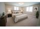 Staged bedroom with neutral walls, carpet, decorative plants and modern furnishings at 105 E North Branch Rd, Ruskin, FL 33570