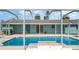 Backyard pool area with sliding doors and a large screened-in pool at 105 E North Branch Rd, Ruskin, FL 33570