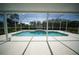 Screened-in swimming pool with clear blue water and a spacious patio area at 105 E North Branch Rd, Ruskin, FL 33570