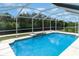 Inviting screened-in pool next to a peaceful waterway and lush landscaping at 105 E North Branch Rd, Ruskin, FL 33570