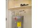 Energy-efficient Rheem water heater with visible plumbing and insulation in the utility closet at 105 E North Branch Rd, Ruskin, FL 33570