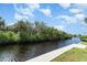 Scenic waterfront view features a wood dock, tranquil canal, and lush foliage, enhancing the property's appeal at 105 E North Branch Rd, Ruskin, FL 33570