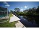 Waterfront view featuring a private dock and lush tropical landscaping at 105 E North Branch Rd, Ruskin, FL 33570