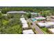Scenic aerial view of neighborhood featuring mature trees, community pool, and nearby recreational facilities at 1102 Cara Dr, Largo, FL 33771