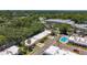 Aerial view showcasing the community with lush greenery, swimming pool, and well-maintained buildings at 1102 Cara Dr, Largo, FL 33771
