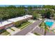 Aerial view of a well-maintained community featuring a sparkling pool, lush landscaping, and tidy homes at 1102 Cara Dr, Largo, FL 33771