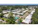 Scenic aerial view of neighborhood featuring mature trees, community pool, and well-maintained lawns at 1102 Cara Dr, Largo, FL 33771