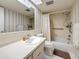 Bathroom featuring a vanity, toilet, mirror, and a bathtub with shower curtain at 1102 Cara Dr, Largo, FL 33771