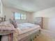 Bedroom showcasing a bed with decorative pillows, and a closet with louvered doors at 1102 Cara Dr, Largo, FL 33771