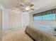 Bedroom featuring neutral carpet, ceiling fan, window with valance, and closet at 1102 Cara Dr, Largo, FL 33771