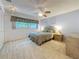 Cozy bedroom with neutral carpet, window with valance, and ceiling fan at 1102 Cara Dr, Largo, FL 33771