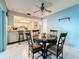Cozy dining area featuring a marble table, adjacent to the kitchen with bar seating at 1102 Cara Dr, Largo, FL 33771