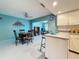 Cozy dining area adjacent to kitchen with a round table and decorative wall art at 1102 Cara Dr, Largo, FL 33771