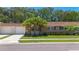 Charming home exterior featuring a well-manicured lawn, decorative stone accents and a two-car garage at 1102 Cara Dr, Largo, FL 33771