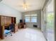 Bright Florida Room with neutral tones, desk and slider doors to the outdoors at 1102 Cara Dr, Largo, FL 33771