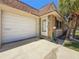 Inviting entrance featuring attached garage, well-maintained landscaping, and a white front door at 1102 Cara Dr, Largo, FL 33771