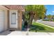Inviting front entrance with a charming white door and stone accents, surrounded by lush landscaping at 1102 Cara Dr, Largo, FL 33771