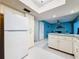 Spacious kitchen with adjacent eating area, white cabinetry and modern refrigerator at 1102 Cara Dr, Largo, FL 33771