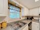 Kitchen featuring a stainless steel double sink and views to the outdoors at 1102 Cara Dr, Largo, FL 33771