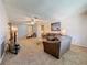 Inviting living room featuring a ceiling fan, cozy furniture, and an open view into the kitchen at 1102 Cara Dr, Largo, FL 33771
