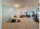Spacious living room with carpeted floors, lots of seating, and backyard views at 1102 Cara Dr, Largo, FL 33771