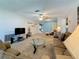 Comfortable living room featuring plush carpeting, ceiling fan and cozy seating arrangement at 1102 Cara Dr, Largo, FL 33771