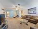 Bright living room with comfortable seating, carpeted floors, and an open layout with backyard views at 1102 Cara Dr, Largo, FL 33771