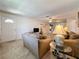 Spacious living room with cozy seating, carpeted floors, and backyard views through a window at 1102 Cara Dr, Largo, FL 33771