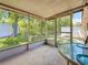 The screened-in patio overlooks the yard and is surrounded by mature trees at 1102 Cara Dr, Largo, FL 33771