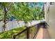 A fenced backyard with a small patio provides a private outdoor area, complemented by lush lawn and mature trees at 115 W Hiawatha St, Tampa, FL 33604