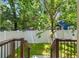 A verdant backyard with privacy fencing, mature trees, and well-manicured lawn provides a serene outdoor retreat at 115 W Hiawatha St, Tampa, FL 33604