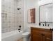Bathroom with decorative wall tile, modern fixtures, and cherry wood vanity at 115 W Hiawatha St, Tampa, FL 33604