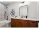 Bright bathroom featuring patterned tile, modern vanity, black fixtures, and decorative square art at 115 W Hiawatha St, Tampa, FL 33604
