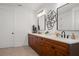 Bathroom showcasing dual sinks, dark fixtures and geometric wall art at 115 W Hiawatha St, Tampa, FL 33604