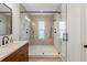 Beautiful bathroom featuring walk-in shower, dark fixtures, and sleek vanity at 115 W Hiawatha St, Tampa, FL 33604
