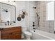 This bathroom features a tub with patterned tile and a modern vanity with sleek black fixtures at 115 W Hiawatha St, Tampa, FL 33604