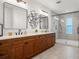 Modern bathroom featuring double vanity, walk-in shower with elegant tile at 115 W Hiawatha St, Tampa, FL 33604
