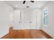 A bedroom with hardwood floors, white trim, a ceiling fan, and a double closet at 115 W Hiawatha St, Tampa, FL 33604