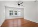 Bedroom features hardwood floors, natural light from multiple windows, and a ceiling fan at 115 W Hiawatha St, Tampa, FL 33604