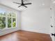 Bedroom with hardwood floors, fan, and large windows at 115 W Hiawatha St, Tampa, FL 33604