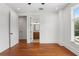 Bedroom with hardwood floors, ceiling fan, two closets, and an open bathroom at 115 W Hiawatha St, Tampa, FL 33604