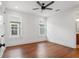 Bright bedroom with hardwood floors, a ceiling fan, and natural light from two windows at 115 W Hiawatha St, Tampa, FL 33604