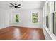 Bedroom with hardwood floors, natural light from windows, and a ceiling fan at 115 W Hiawatha St, Tampa, FL 33604