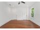 Bright bedroom with hardwood floors, a ceiling fan, and natural light from window at 115 W Hiawatha St, Tampa, FL 33604