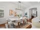 Dining room with designer light fixture, seating for eight, and view into the living area at 115 W Hiawatha St, Tampa, FL 33604