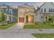 Inviting home featuring a well-manicured lawn, covered porch, and a charming two-story design with a private garage at 115 W Hiawatha St, Tampa, FL 33604
