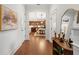 Bright foyer featuring hardwood floors, mirror, and views into the kitchen and dining area at 115 W Hiawatha St, Tampa, FL 33604