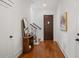 Bright foyer featuring hardwood floors, staircase with iron railing, and door to the exterior at 115 W Hiawatha St, Tampa, FL 33604